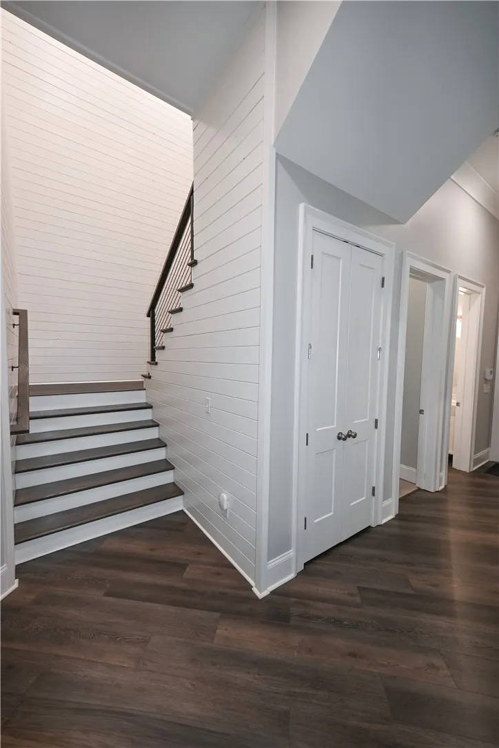 Shiplap walls add style to this extra-wide stairway.