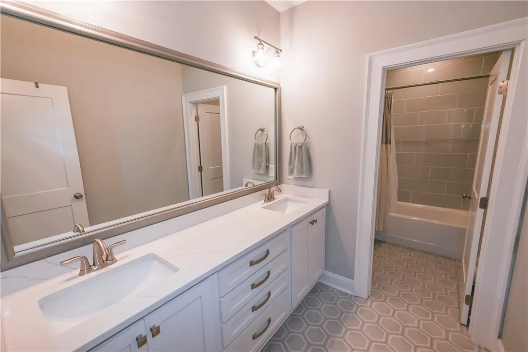 Upstairs hall bath includes separate dressing area with extended double sink vanity.