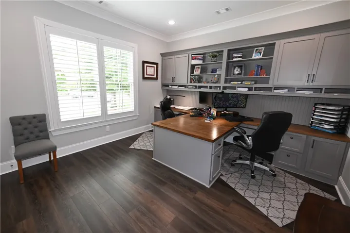 Custom built-in desks with ample workspace and storage turn this main level guest room into an organized and productive home office setting.
