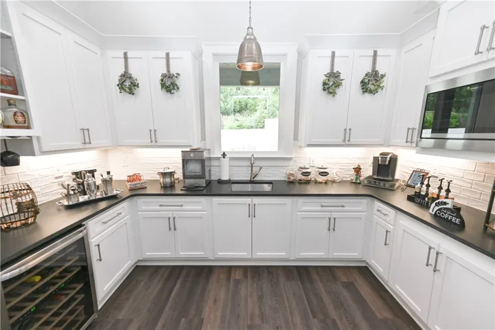 Here you have the second, "prep" kitchen, which includes a sink, microwave, wine fridge, and TONS of extra storage!