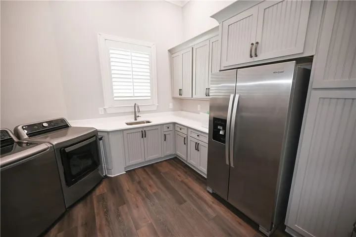 Ample counter space, sink, storage, and window make laundry (almost!) enjoyable.....