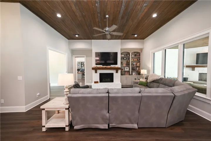 The great room's fireplace and wood ceiling are cleverly echoed in the outdoor living space!