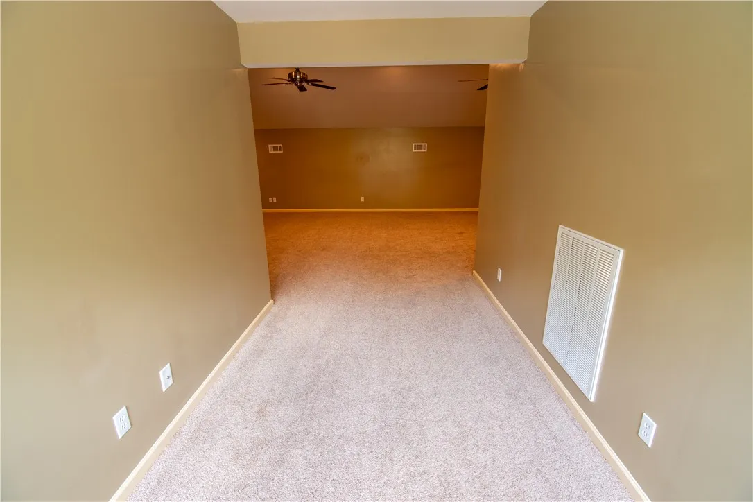 A spacious carpeted loft area provides a flexible living space.