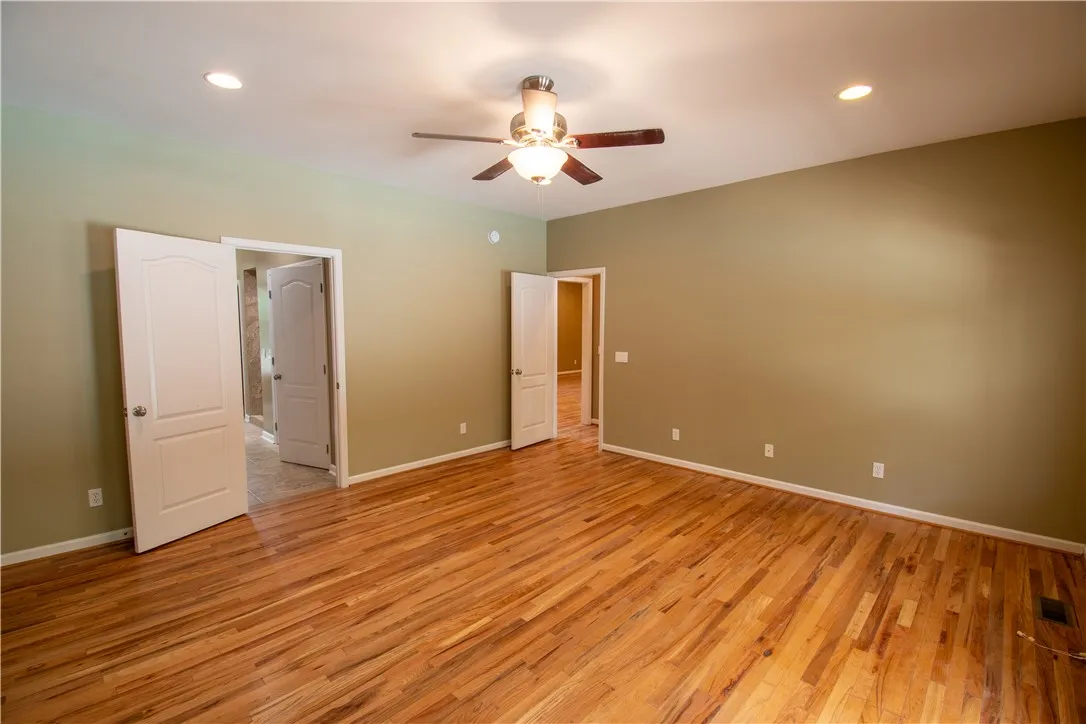 Lustrous hardwood floors create an inviting atmosphere in this generous room.