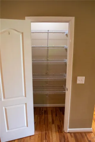 A well-organized closet with ample shelving provides abundant storage space.