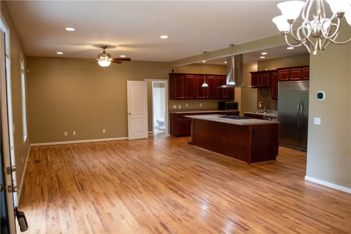 An open-concept layout unites the kitchen and living spaces, all floored with gleaming hardwood.
