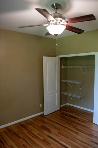 Hardwood floors and ample storage define this versatile bedroom space.