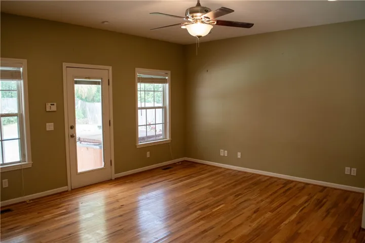 Warm hardwood floors and abundant natural light create an inviting atmosphere.