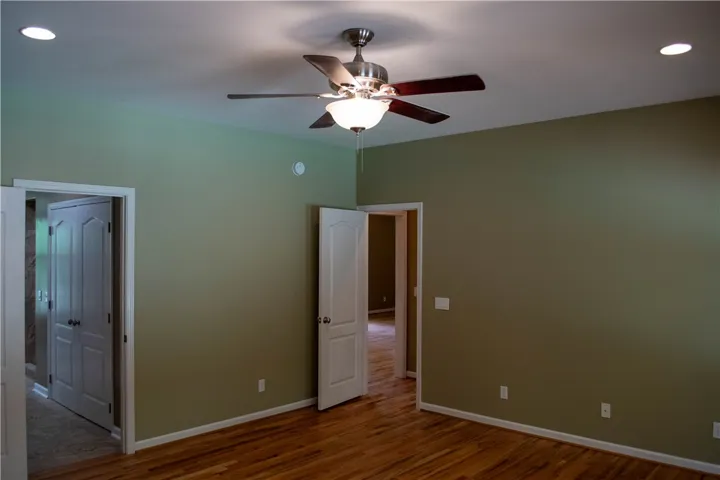 Hardwood flooring extends throughout this versatile room, offering warm tones underfoot.
