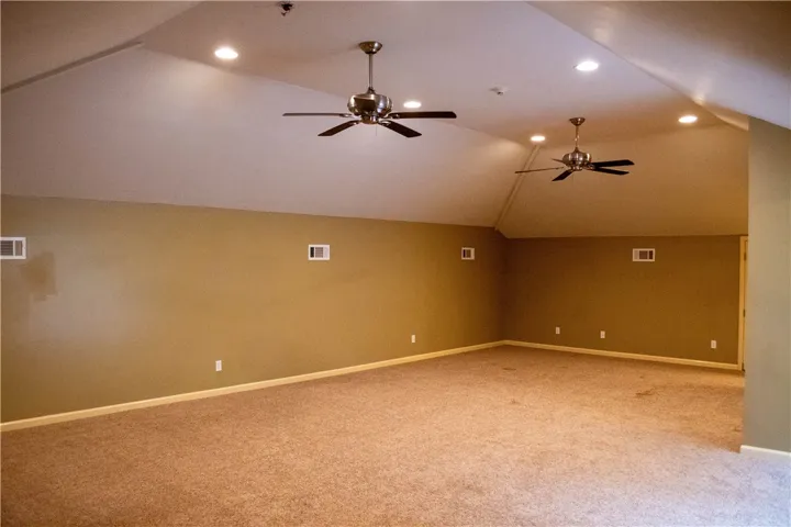 An airy loft with sloped ceilings and ample floor space awaits your creative vision.