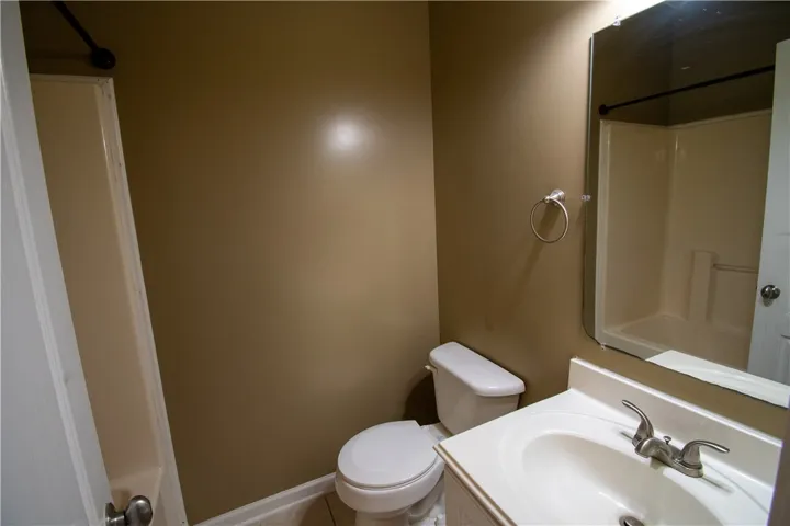 A well-appointed bath features a sleek vanity, toilet, and an integrated shower/tub combination.