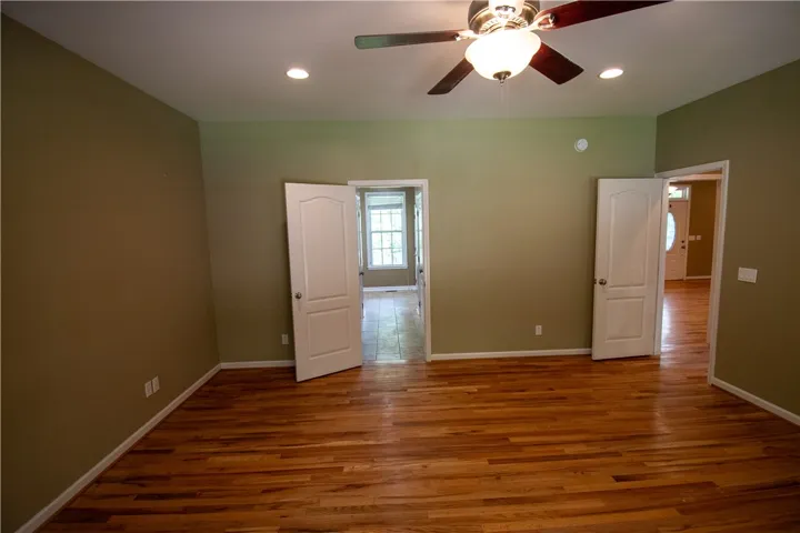 Rich hardwood floors complement neutral walls in this versatile interior space, perfect for any use.