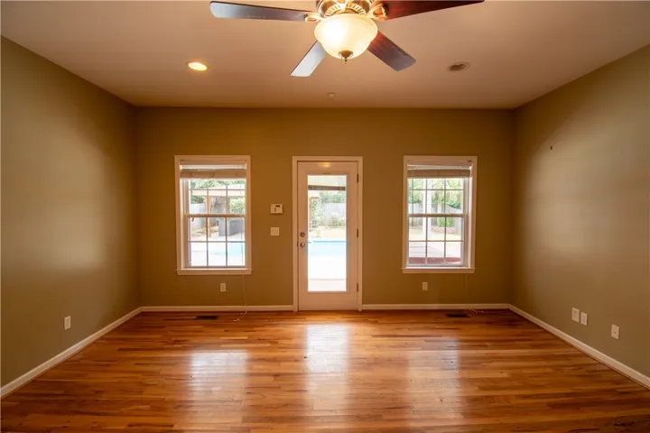 Hardwood floors and generous windows create a light-filled living space with outdoor access.