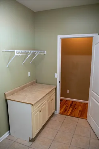 A well-appointed utility space features practical shelving and a convenient folding counter.