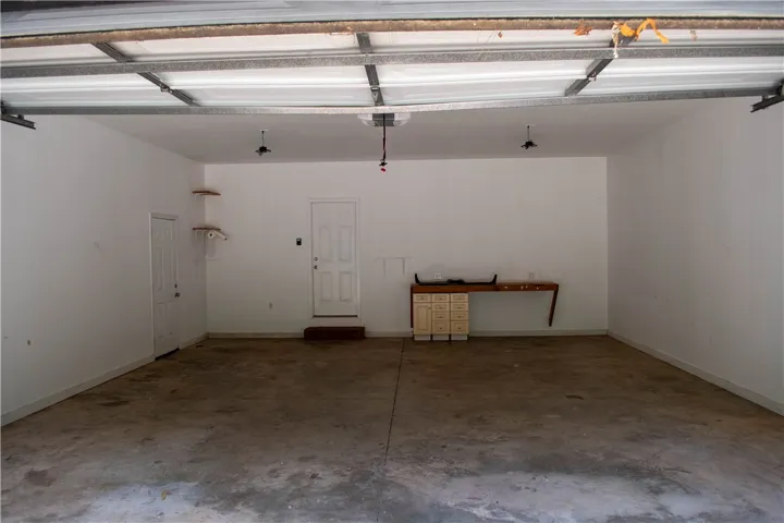 Ample two car garage space for vehicles and storage.