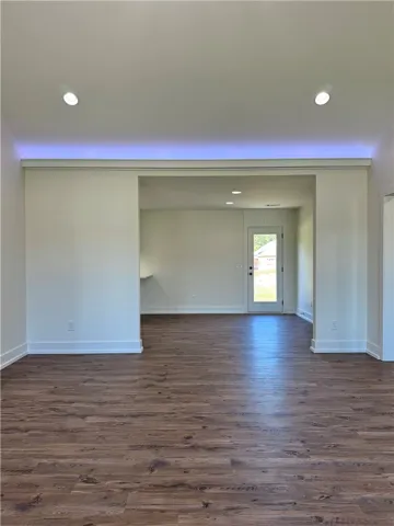 Gleaming hardwood floors and recessed lighting enhance the open layout of this modern space.