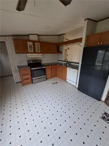 A well-appointed kitchen features ample cabinetry and a suite of essential appliances.