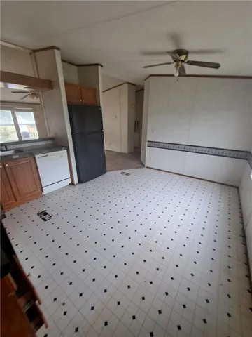 A classic kitchen with durable tile flooring and wood cabinetry awaits your personal touch.