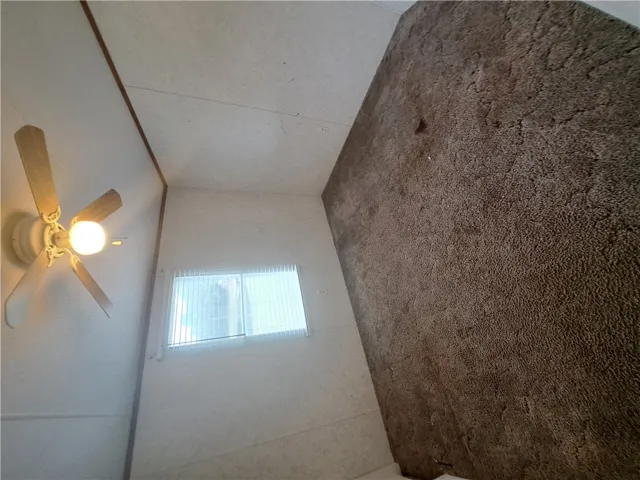 Functional ceiling fan and textured flooring offer everyday comfort.