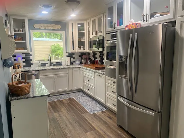 A well-appointed kitchen showcasing elegant cabinetry and modern stainless steel appliances.