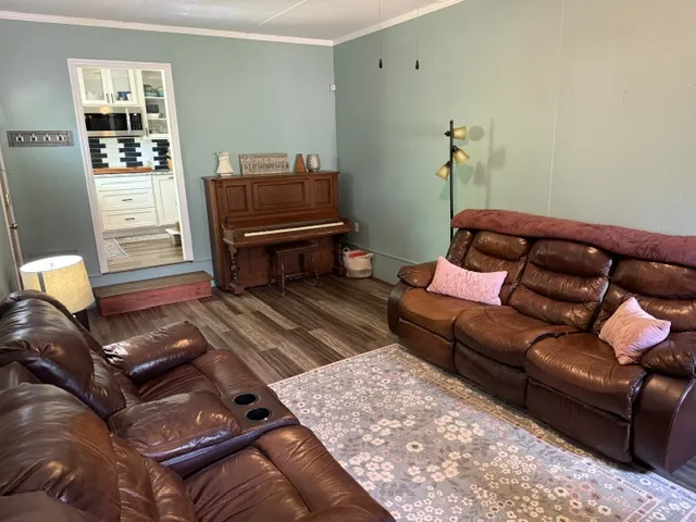 Hardwood floors and ample light define this inviting living space with a classic piano.