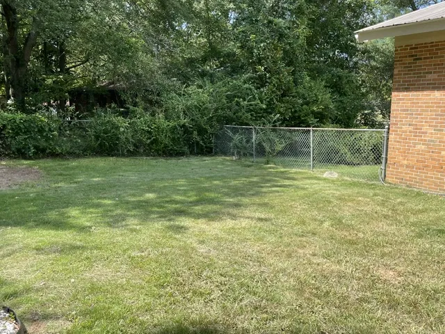 A generous backyard offers a private outdoor space for leisure and recreation.