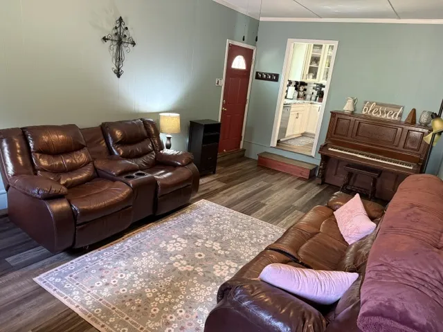 Rich hardwood floors complement the warm, inviting ambiance of this well-lit living space.