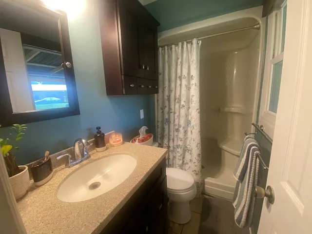 A well-maintained bathroom with a spacious vanity, sleek sink, and convenient shower/tub combination.