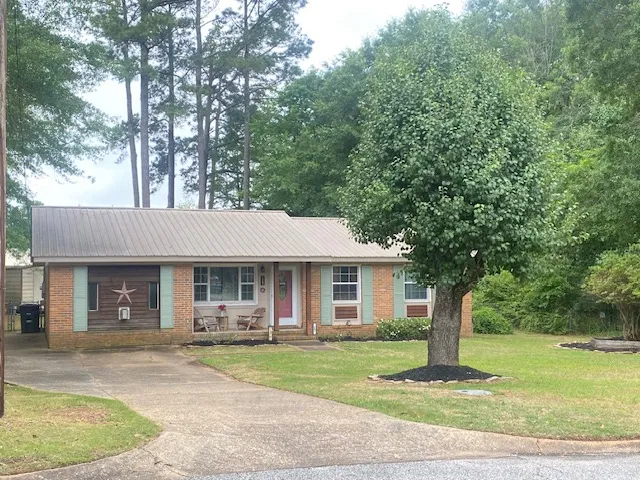 A well-maintained facade with brick accents and a welcoming porch provides charming curb appeal.
