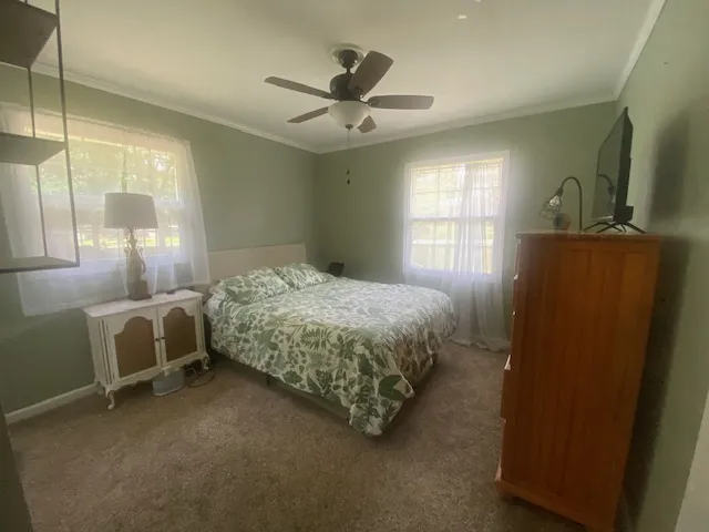 A comfortable bedroom with a ceiling fan offers peaceful repose.