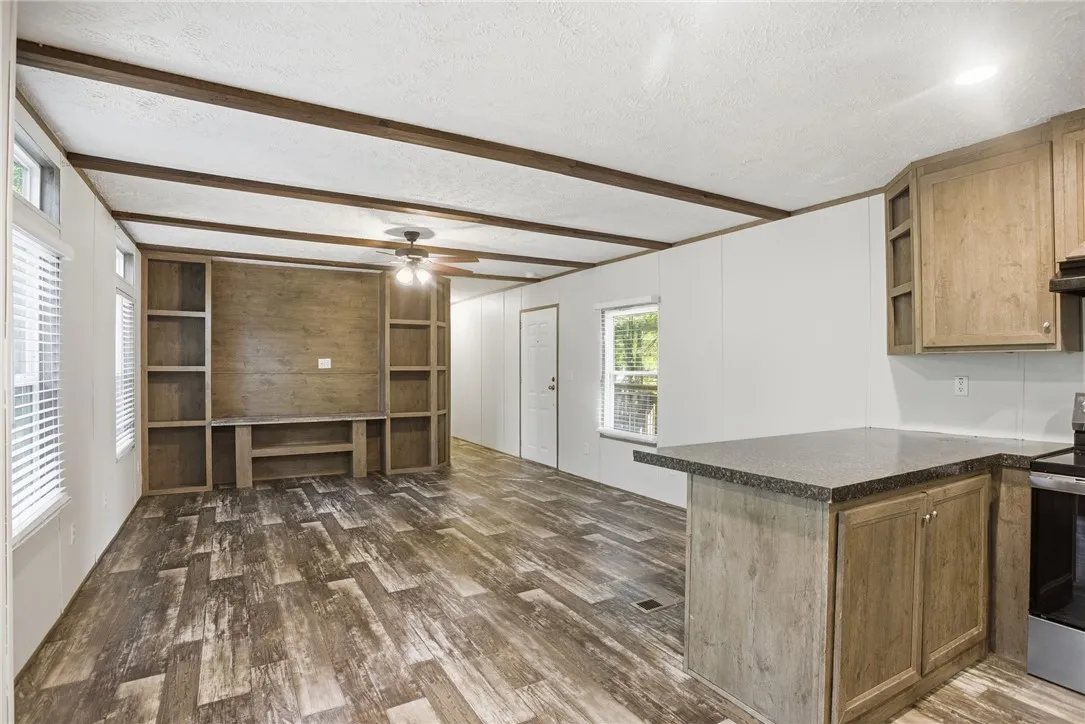A versatile great room featuring built-in shelving, durable flooring, and a welcoming ambiance.