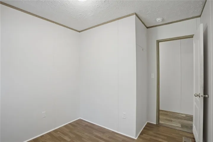 A well-lit, unfurnished room offers flexible living space with durable flooring.
