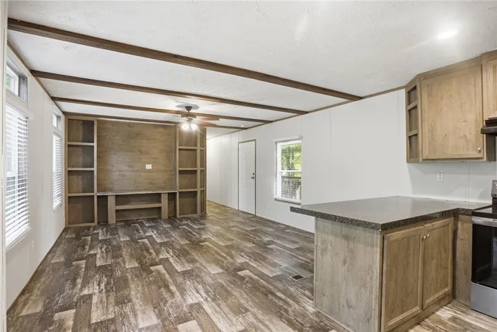 A versatile great room featuring built-in shelving, durable flooring, and a welcoming ambiance.