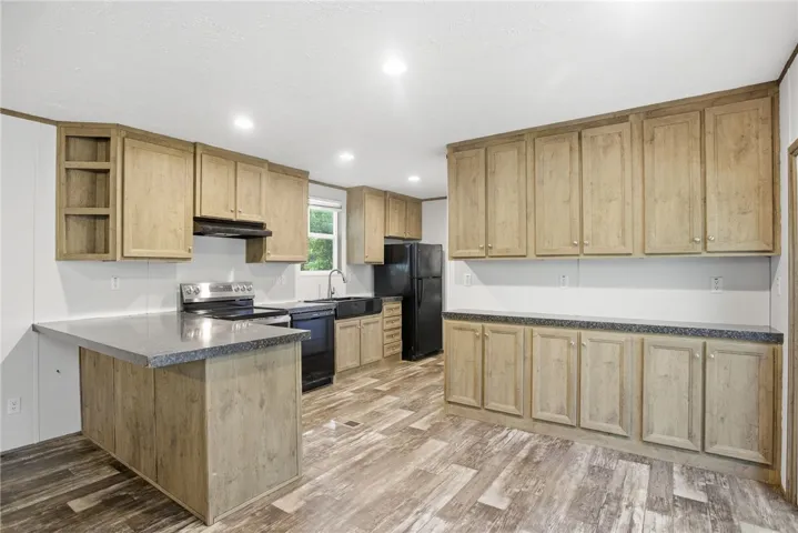 A well-equipped kitchen featuring ample cabinetry and a practical layout for daily living.