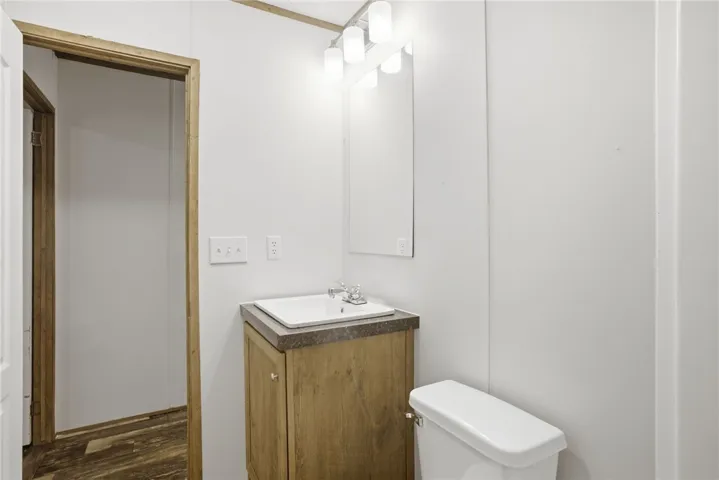 Functional vanity with a neutral countertop and coordinating light fixture elevate this practical space.