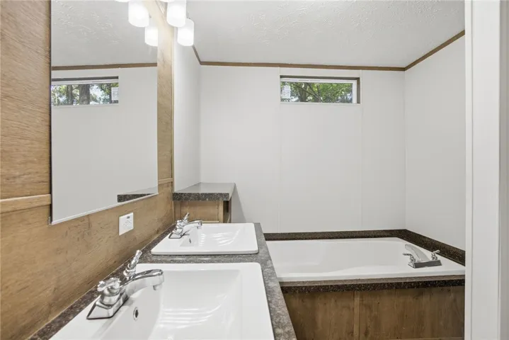 Double vanity and soaking tub create a luxurious bathing space.