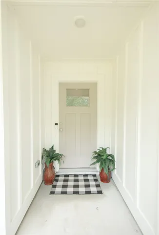 A welcoming front entry features white board and batten siding, creating a distinguished curb appeal.