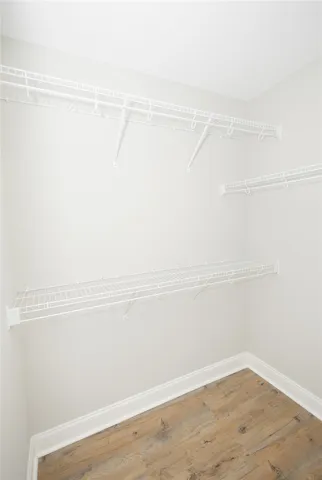 An organized walk-in closet with ample shelving for all storage needs.