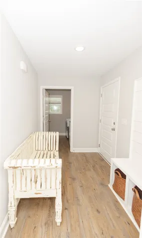 A well-appointed entryway features durable wood-look flooring and a functional mudroom bench.