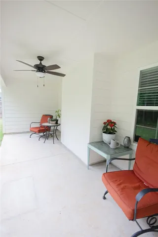 Relax outdoors on this inviting patio, complete with a refreshing ceiling fan.