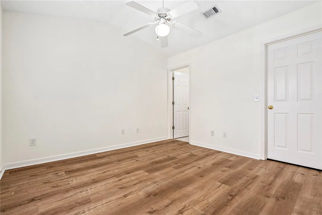 Newly installed wood flooring creates a warm foundation for this versatile room.