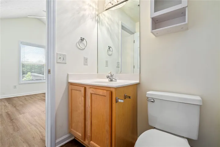 A compact and functional bathroom features a bright vanity and convenient toilet.
