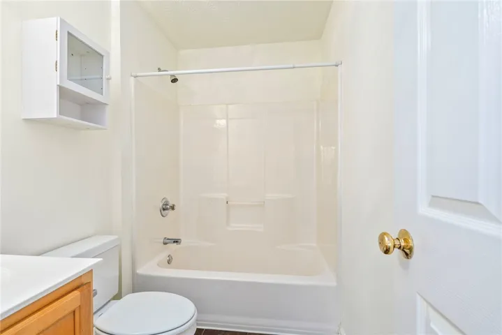 Functional full bathroom featuring a tub-shower combination, ready for personalization.