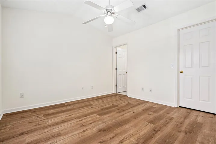Newly installed wood flooring creates a warm foundation for this versatile room.