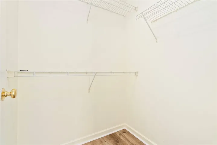 Functional wire shelving provides ample storage in this well-appointed walk-in closet.