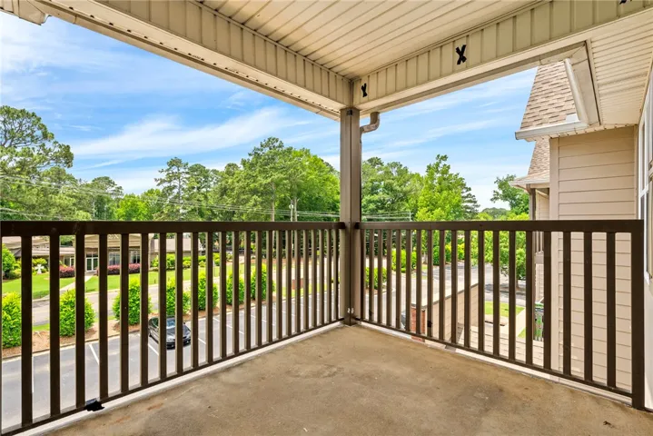 Enjoy outdoor living with elevated views from this private balcony overlooking lush greenery.