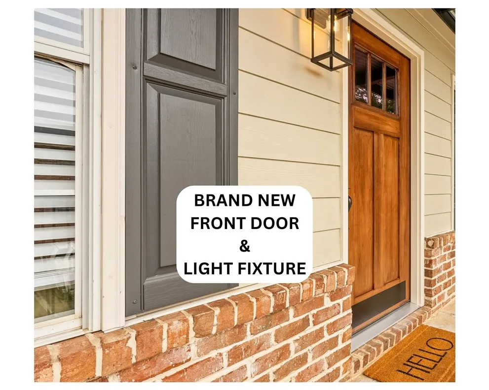 A welcoming entry features a rich wooden door and classic brick accents.