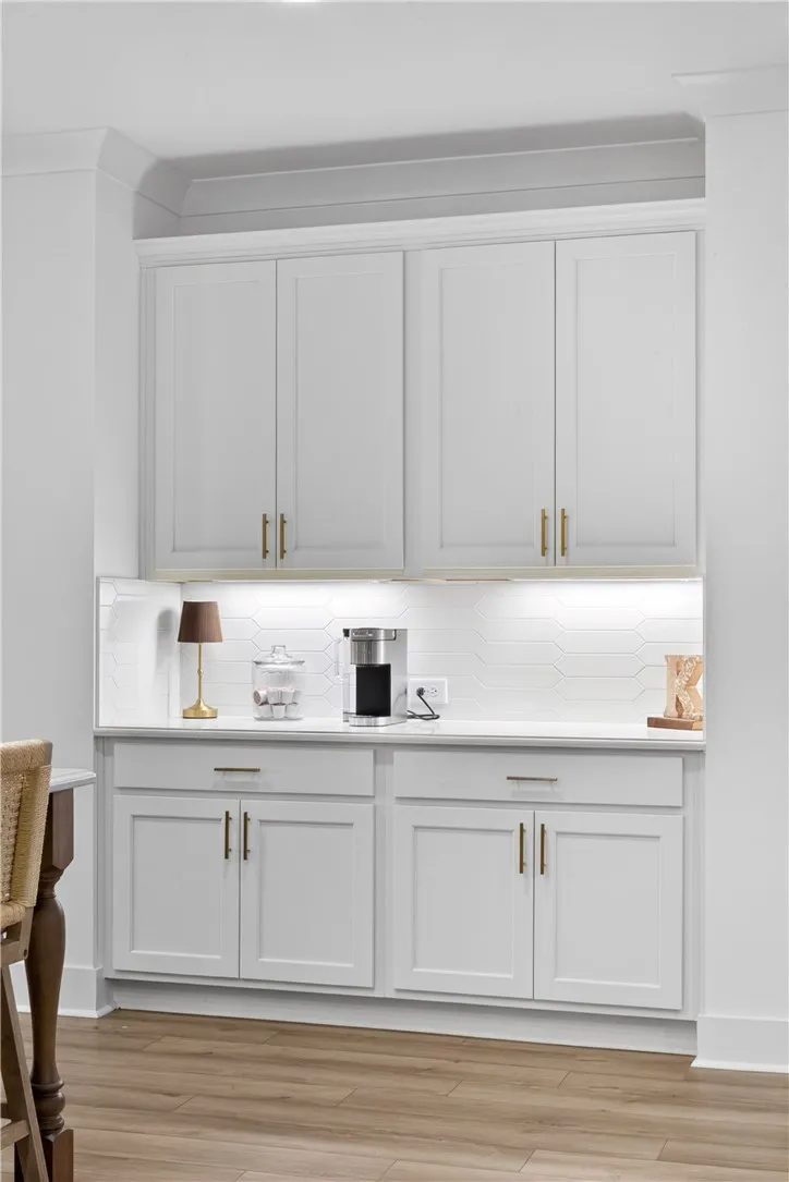 A well-appointed coffee bar with a stylish backsplash, offering convenient refreshment.