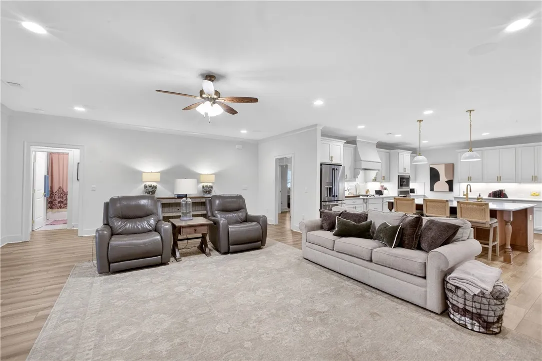 An inviting open-concept living space seamlessly merges with a modern, well-appointed kitchen.