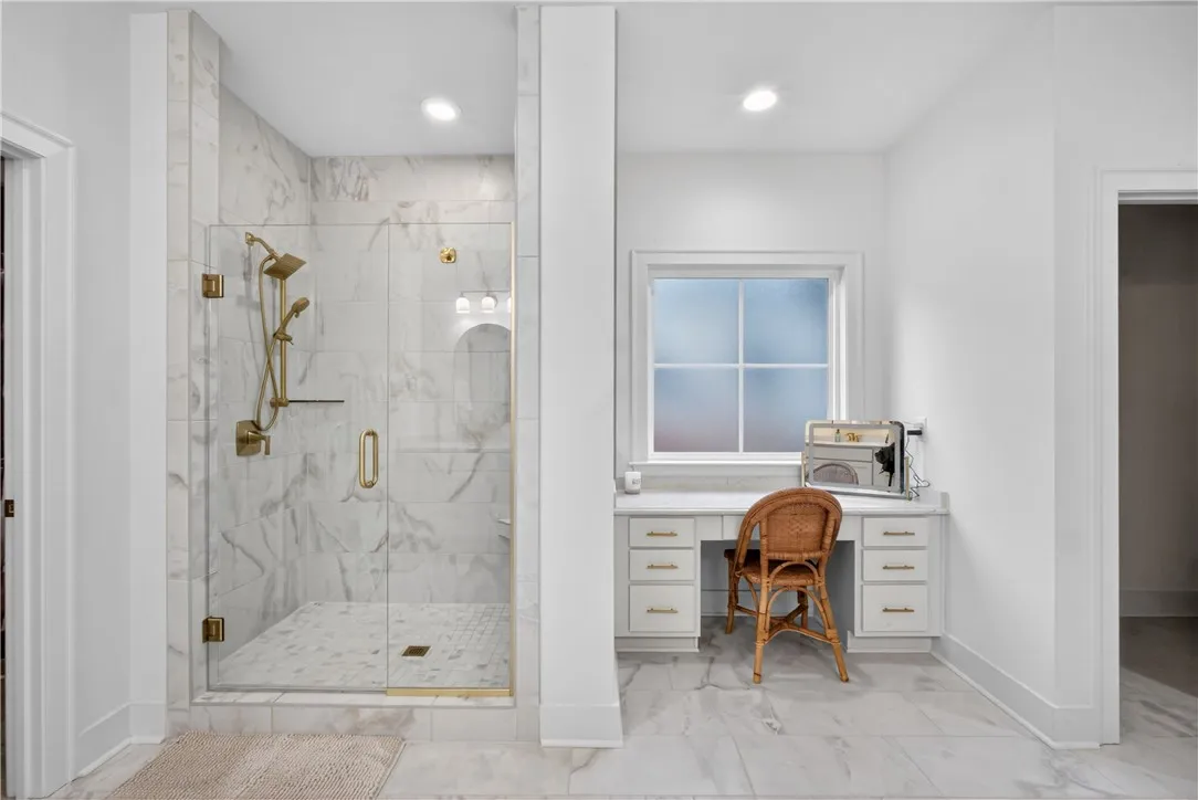 Luxurious bathroom retreat with a spacious walk-in shower and elegant tile flooring.